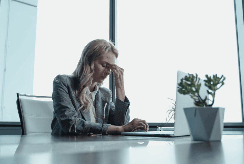 Image is of a professional woman looking upset at her desk, concept of facing professional discipline in Gainesville
