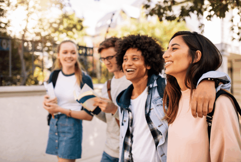 Image is of a group of young men and women college students walking on campus together, concept of UF Title IX investigations