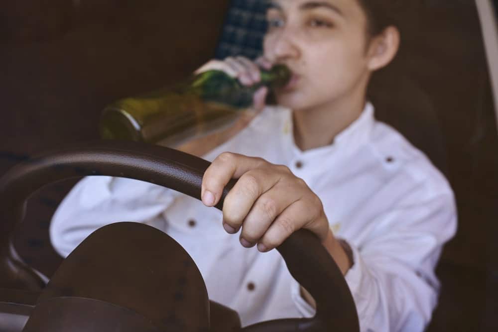 Student drinking while driving representing serious DUI offenses for UF students.
