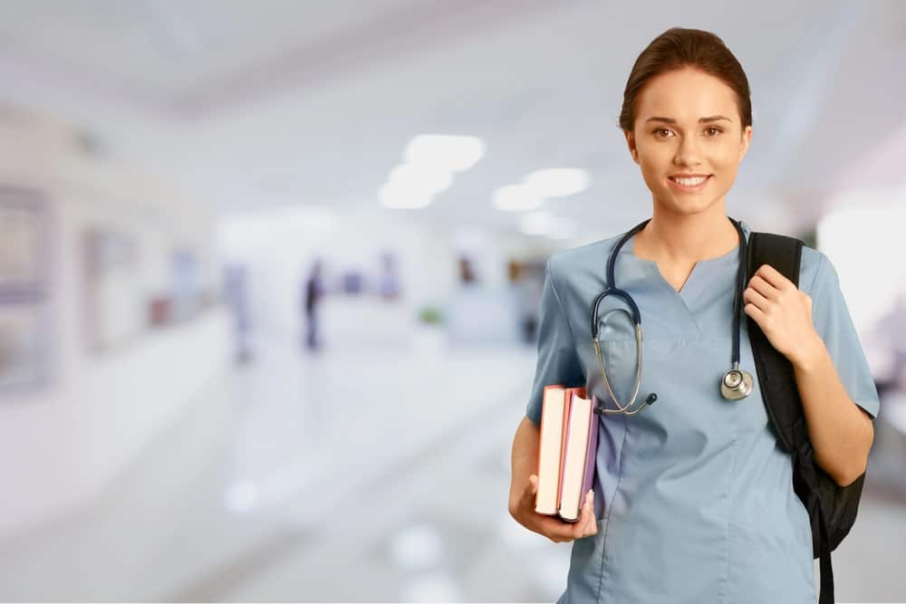 Image is of a medical professional student standing in a hospital hallway, representing how a DUI can impact licensing and careers for DUI and professional program students.