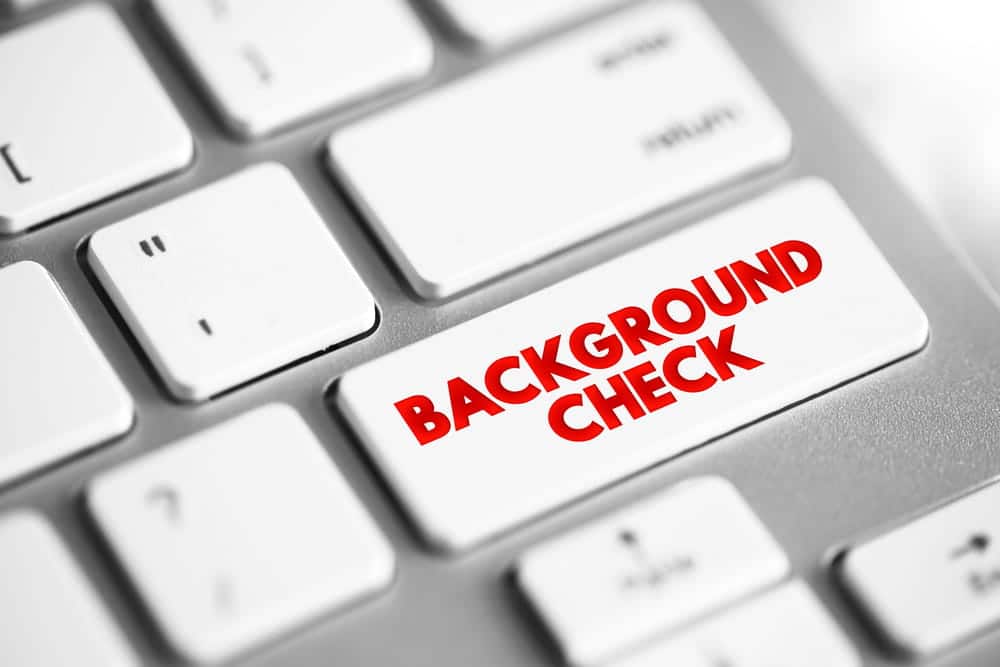 Image is of a computer keyboard highlighting background checks, illustrating how administrative expungement impacts record screening systems
