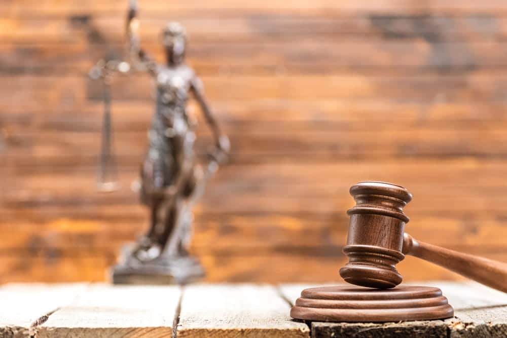 Image is of a judge’s gavel and Lady Justice statue, representing the difference between administrative expungements and court ordered record clearing procedures.