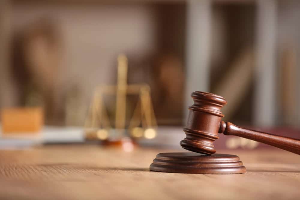 Image is of a judge’s gavel on a courtroom table, concept of expungement in FL and legal decisions following lawful self defense.